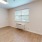 a room with a wood floor and a window