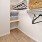 a closet with shelves and hangers